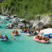 Grupa ludzi na pontonach, rafting Soca - Traveligo Blog