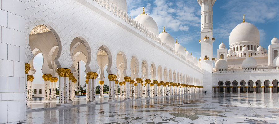 Wielki Meczet Szejka Zayeda w Abu Dhabi – białe arkady i kopuły na marmurowym dziedzińcu