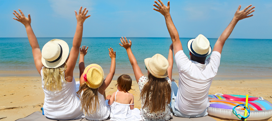 Rodzinne wakacje w maju – rodzina z dziećmi na plaży podczas wakacji all inclusive
